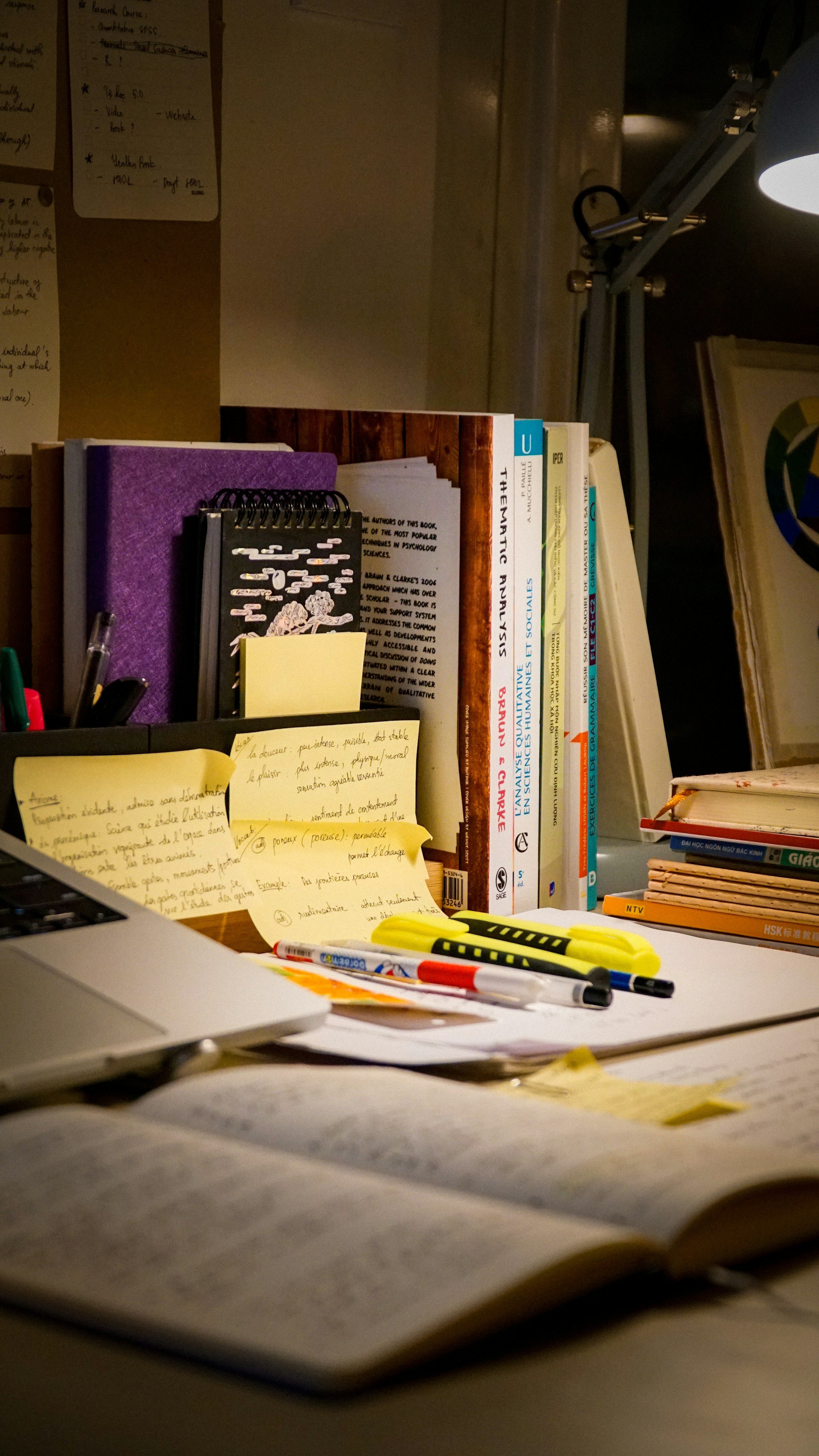 Planning notes, notebook and laptop on a desk