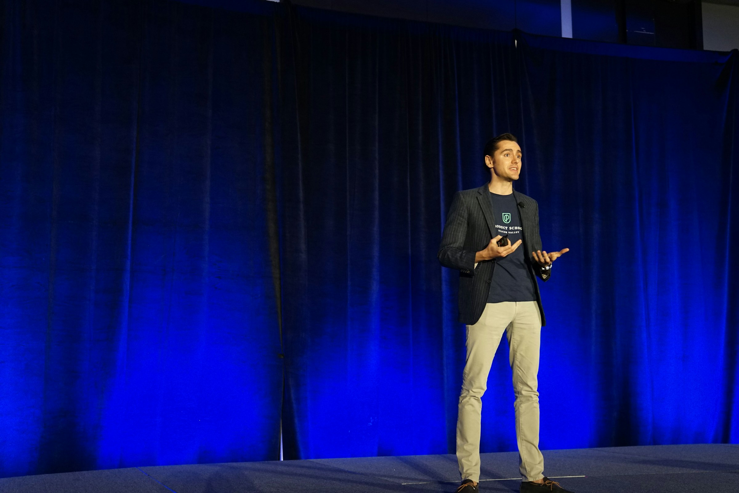 Speaker presenting to an audience on stage